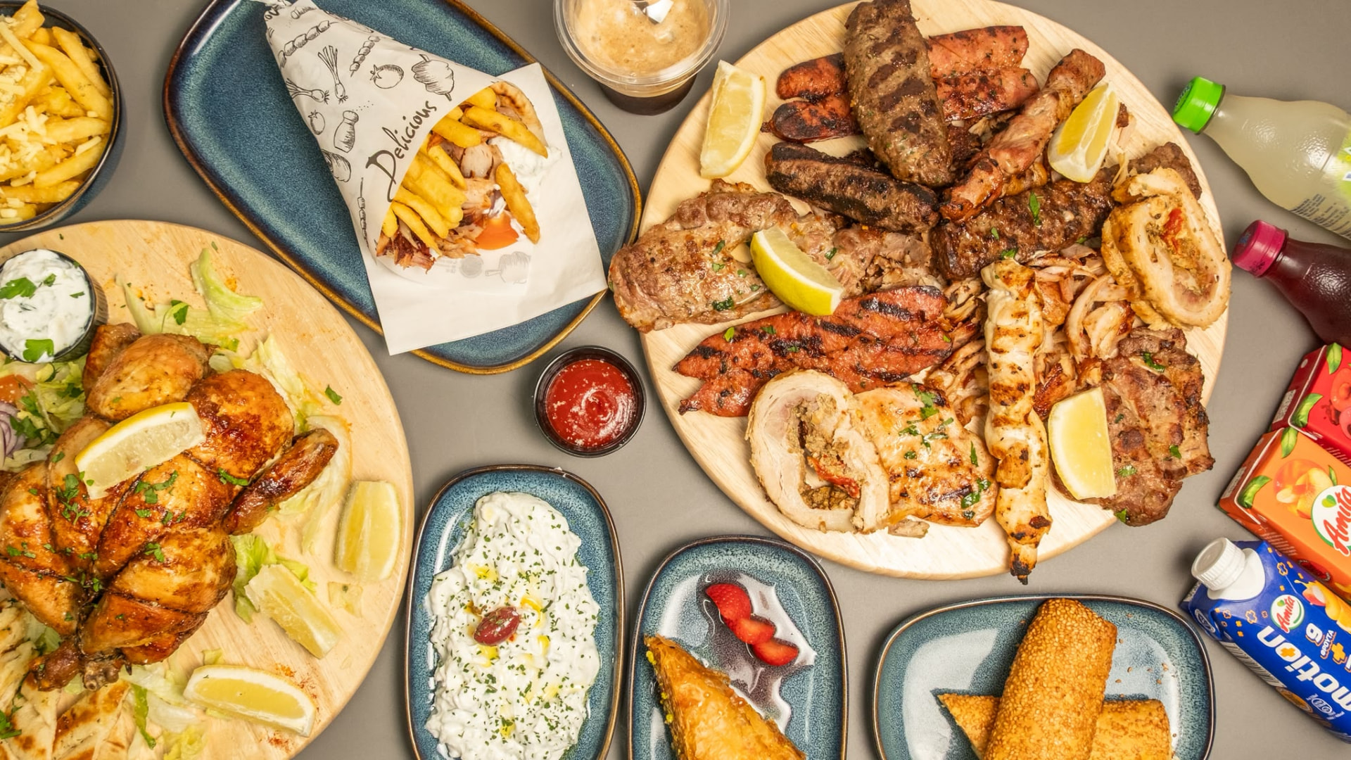 A spread of Greek grilled meats, dips and salads at Mammy's
