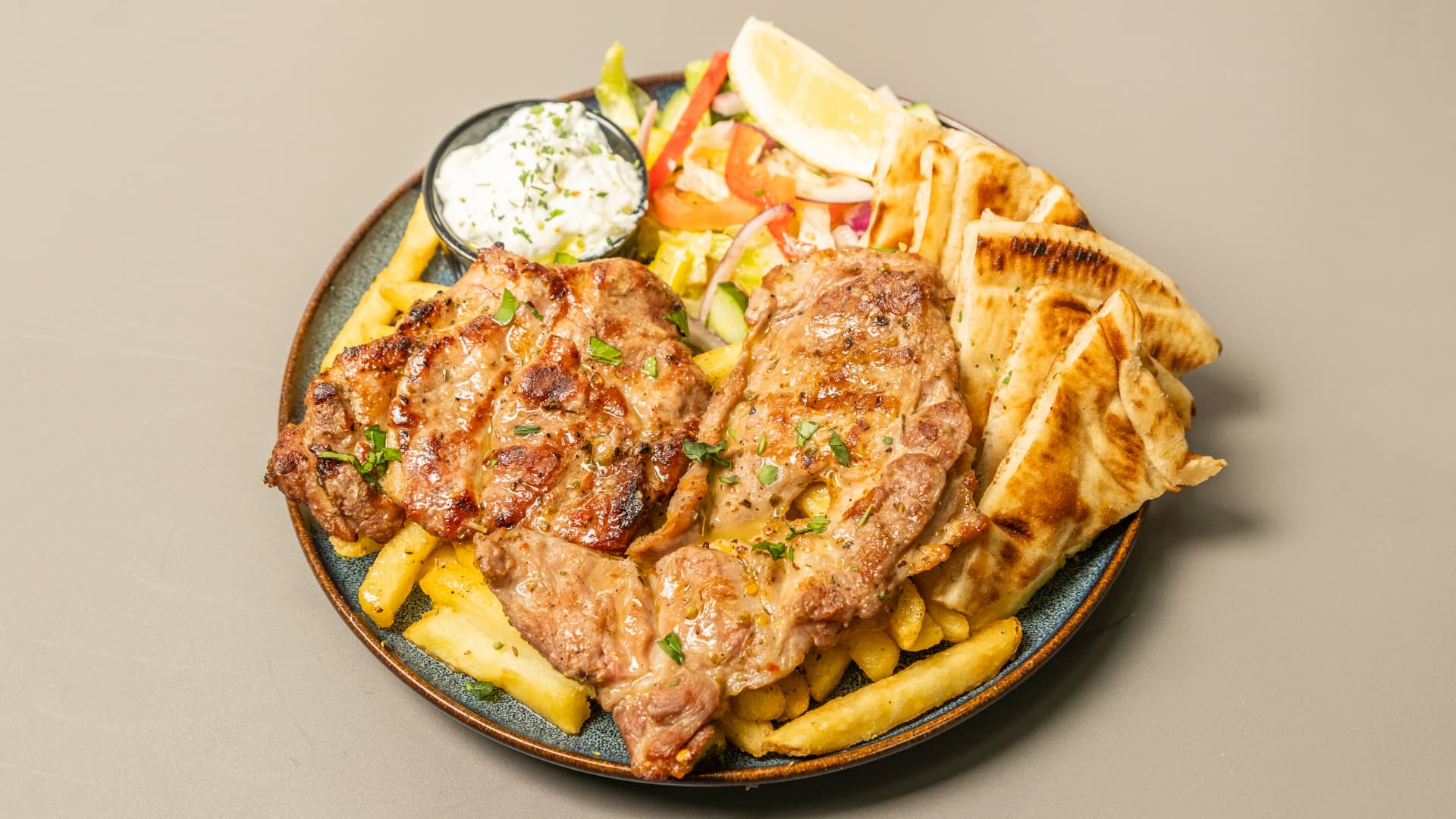 Pork brizolaki with chips, pita and tzatziki